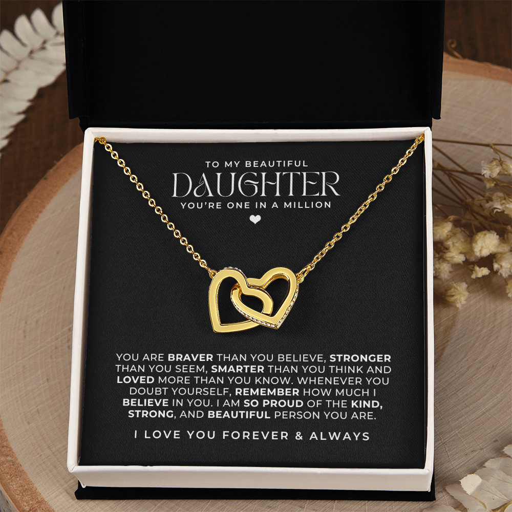 beautiful gold interlocking hearts necklace in a gift box with a message card that says to my daughter and a loving note intended as a birthday gift for her.